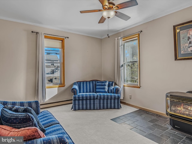 sitting room with crown molding, a baseboard heating unit, a wood stove, and ceiling fan