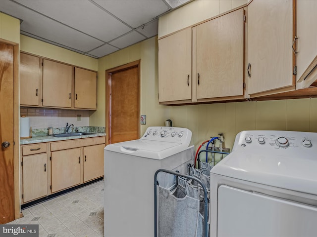 clothes washing area featuring cabinets, separate washer and dryer, and sink