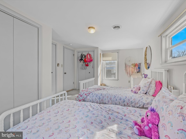 bedroom with multiple windows and carpet flooring