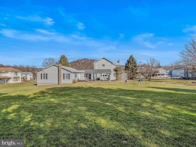 rear view of house with a lawn