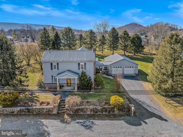 view of front of home with a garage and a mountain view