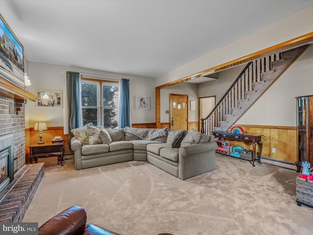 carpeted living room featuring a brick fireplace and wood walls