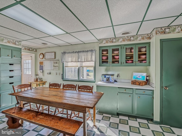 dining space with plenty of natural light and a paneled ceiling