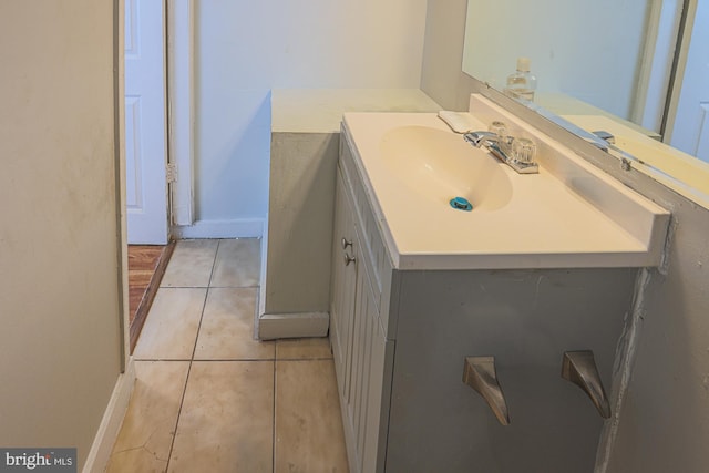 bathroom with baseboards, vanity, and tile patterned floors