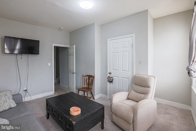 living room featuring carpet and baseboards