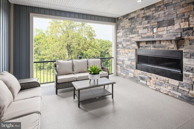 living room featuring an outdoor stone fireplace