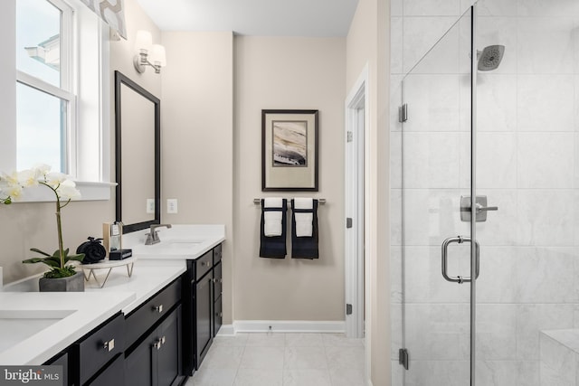 bathroom with vanity, an enclosed shower, and tile patterned flooring