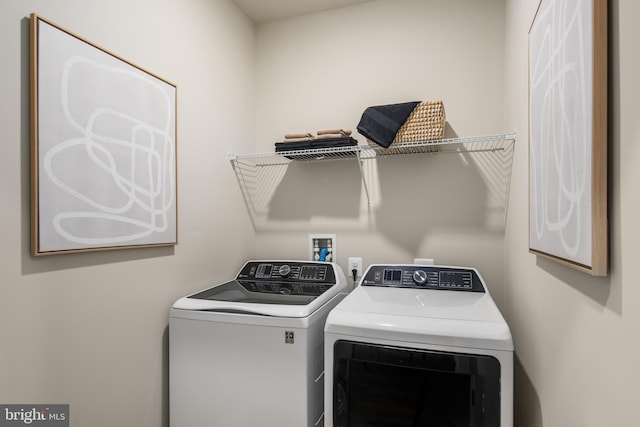 laundry area featuring washing machine and clothes dryer