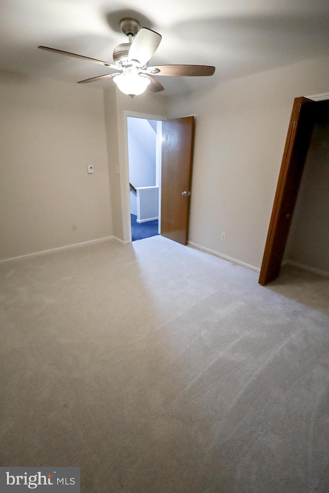 unfurnished room with ceiling fan and light colored carpet