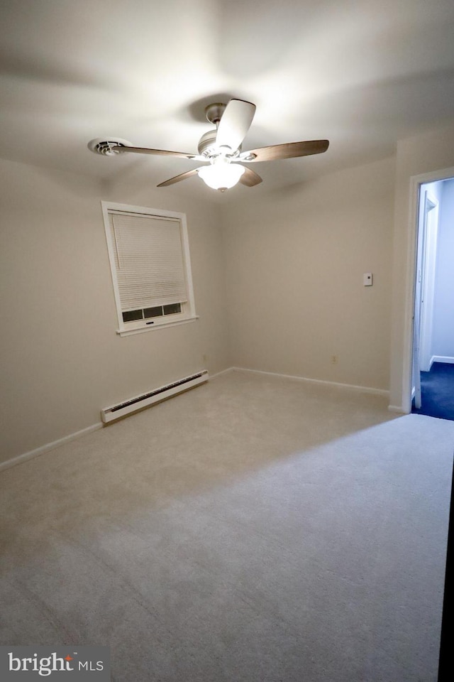 spare room with ceiling fan, a baseboard radiator, and carpet