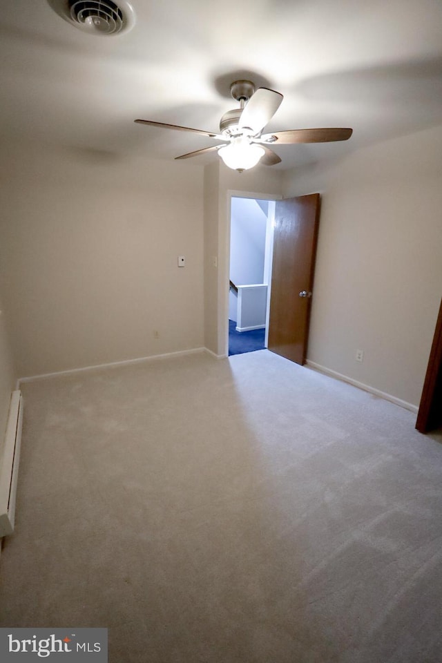 spare room with ceiling fan, carpet flooring, and baseboard heating