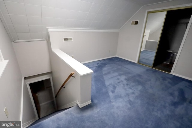 bonus room featuring vaulted ceiling and dark carpet