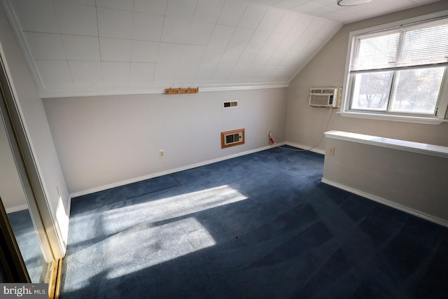 bonus room featuring dark colored carpet, an AC wall unit, heating unit, and lofted ceiling