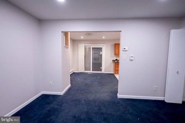 carpeted empty room with a baseboard radiator