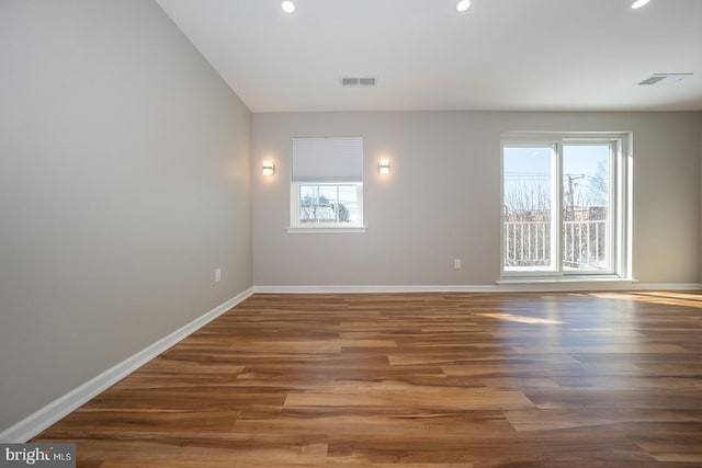 unfurnished room with dark wood-type flooring