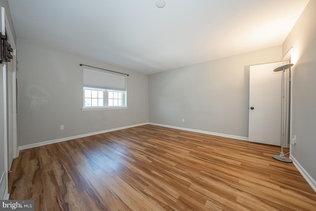 empty room with hardwood / wood-style floors