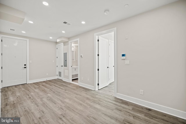 foyer entrance featuring electric panel and light wood-type flooring