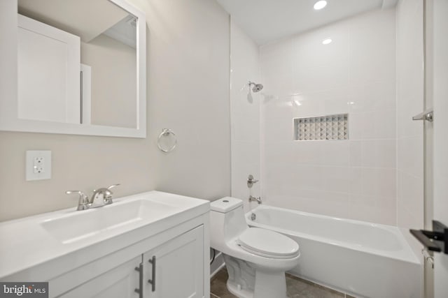 full bathroom with tiled shower / bath combo, vanity, tile patterned flooring, and toilet