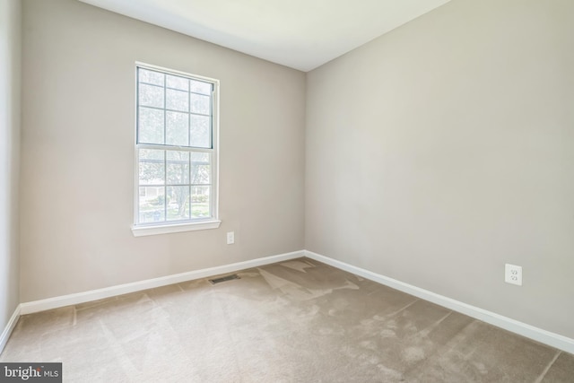 carpeted empty room with a wealth of natural light