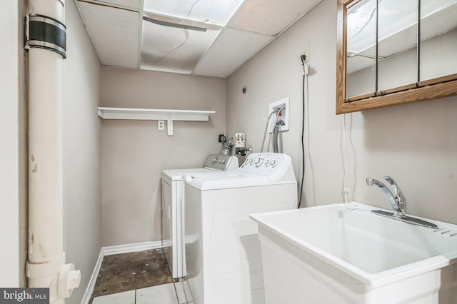 clothes washing area featuring washer and dryer and sink