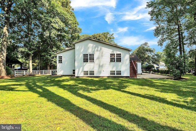 back of property featuring a yard and a patio