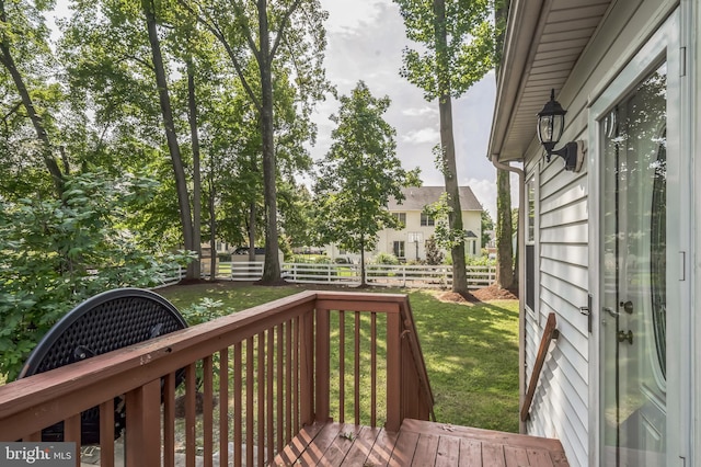 wooden terrace with a lawn