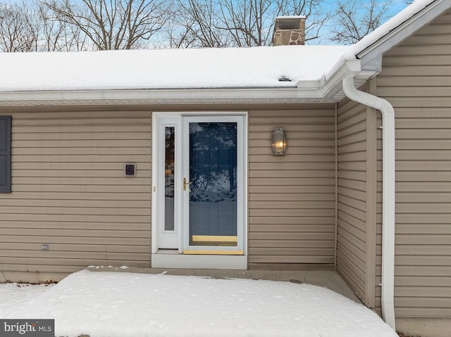 view of snow covered property entrance