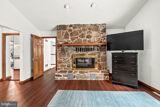 living room with a fireplace, dark wood-type flooring, and vaulted ceiling