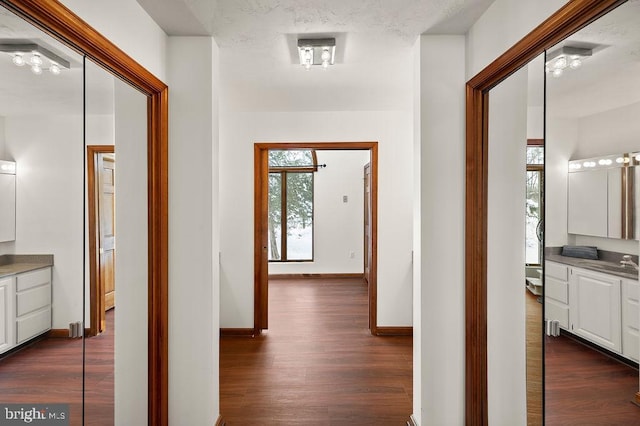 hall featuring dark hardwood / wood-style flooring and sink