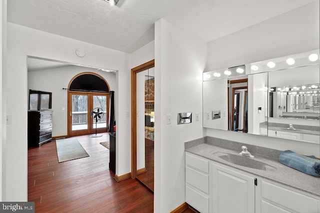 bathroom featuring vanity, hardwood / wood-style floors, and french doors