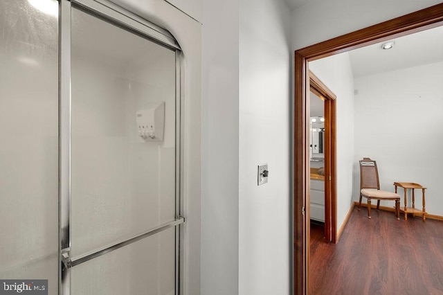 bathroom with walk in shower and hardwood / wood-style flooring