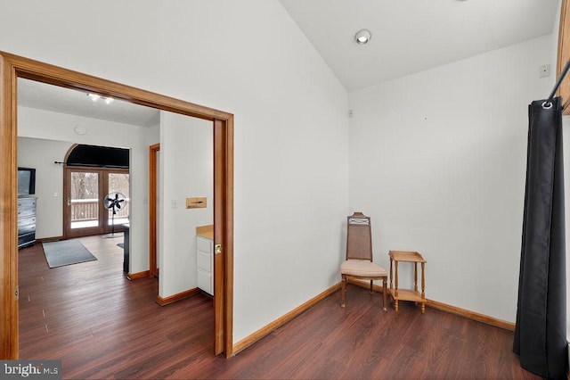 sitting room featuring dark wood-type flooring, lofted ceiling, and french doors