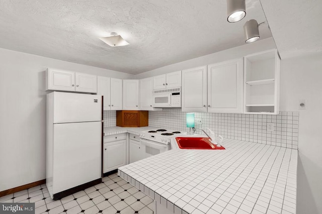 kitchen featuring sink, white cabinetry, tasteful backsplash, kitchen peninsula, and white appliances