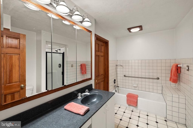 bathroom with vanity, a washtub, and toilet