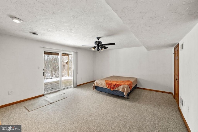 carpeted bedroom with access to outside, a textured ceiling, and ceiling fan