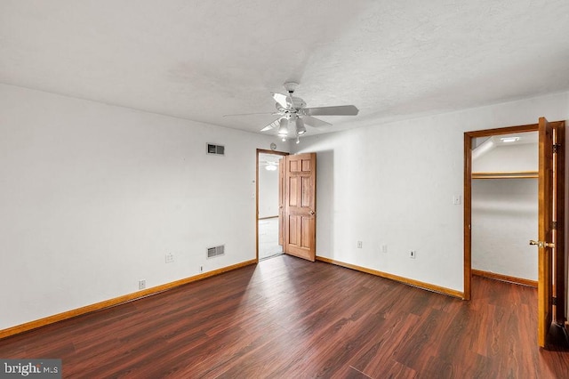 spare room with ceiling fan and dark hardwood / wood-style flooring