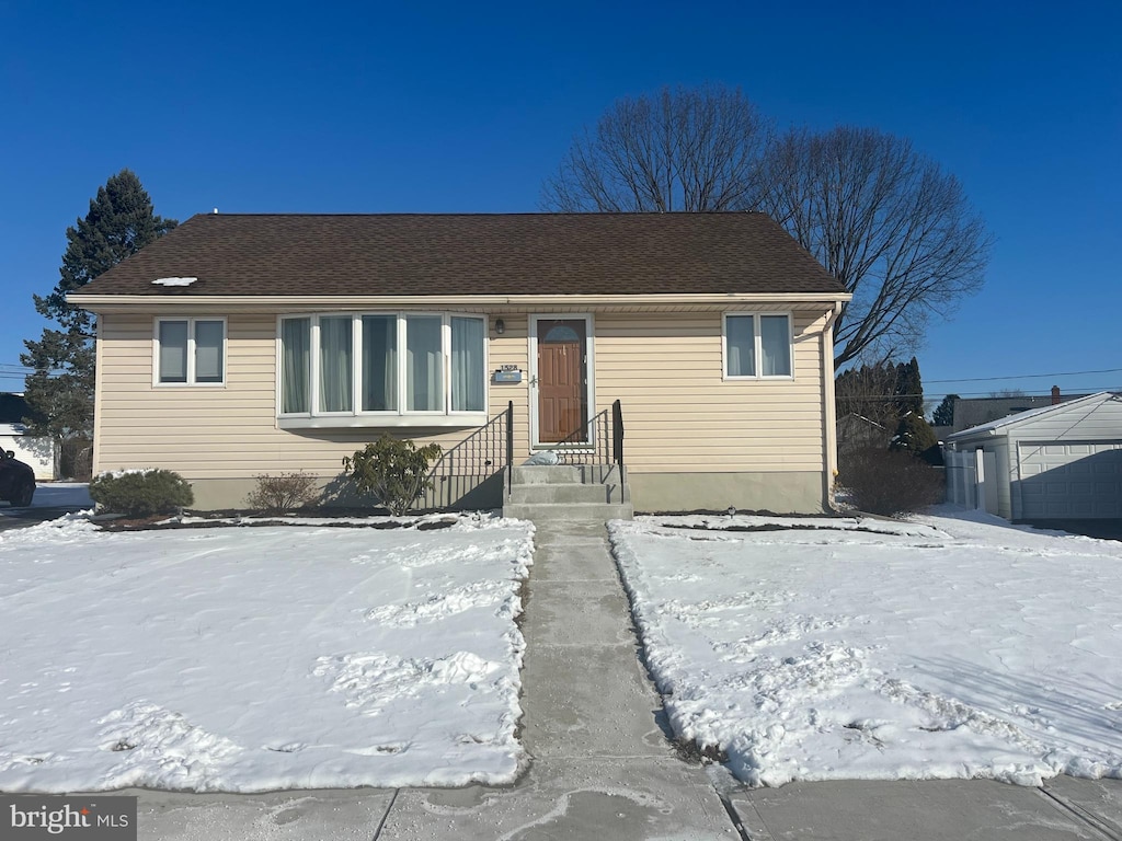 view of front facade with a garage and an outdoor structure