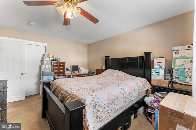 carpeted bedroom with ceiling fan and vaulted ceiling