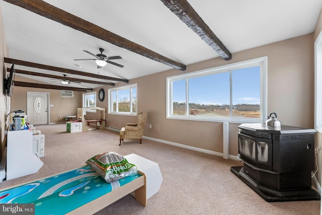 living area with lofted ceiling with beams, light carpet, a wood stove, a baseboard radiator, and a wall unit AC