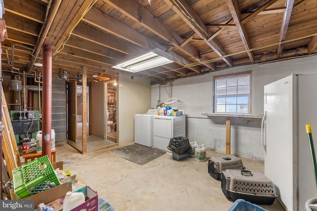 basement with independent washer and dryer and white fridge