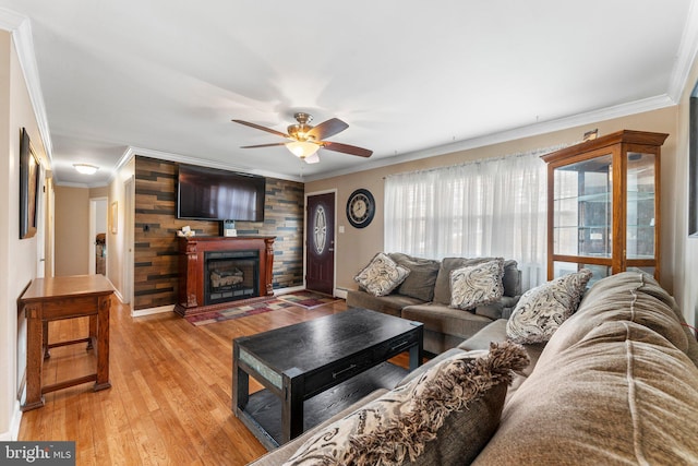 living room featuring crown molding, ceiling fan, hardwood / wood-style floors, and wood walls