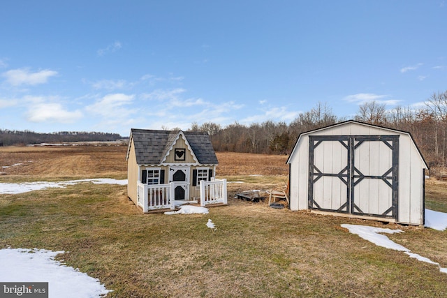 view of outdoor structure featuring a rural view and a lawn