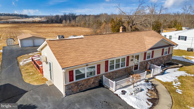 view of front of house with a garage and an outdoor structure