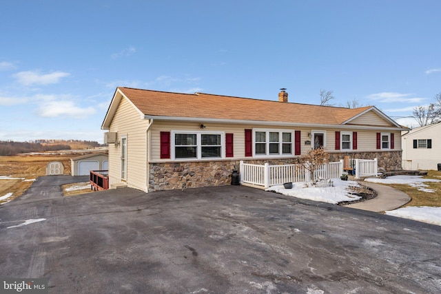 view of front of property with a garage and central AC