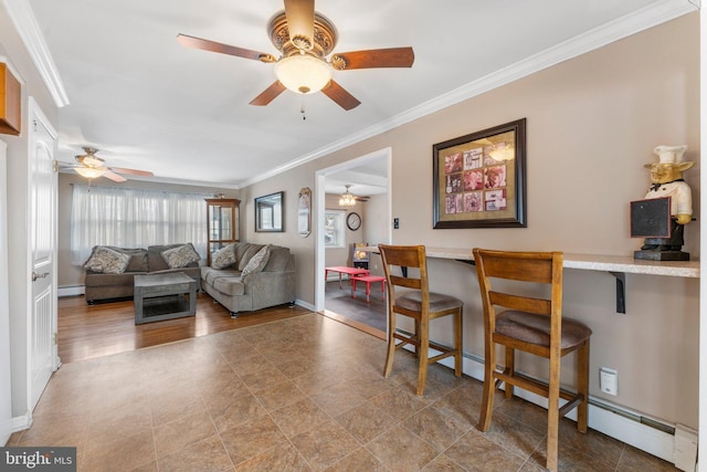 living room with crown molding, ceiling fan, and baseboard heating