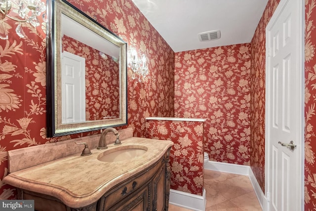 bathroom featuring vanity, tile patterned floors, and toilet