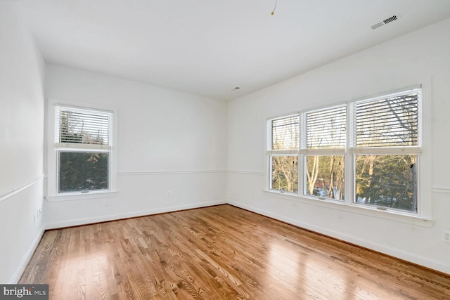 spare room with hardwood / wood-style floors