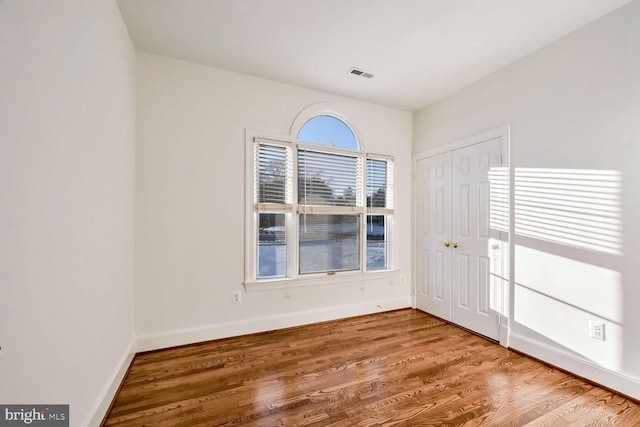 empty room with wood-type flooring