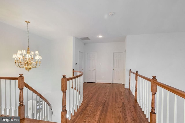 hall featuring dark hardwood / wood-style flooring and a notable chandelier