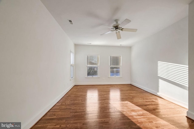 empty room with hardwood / wood-style flooring and ceiling fan